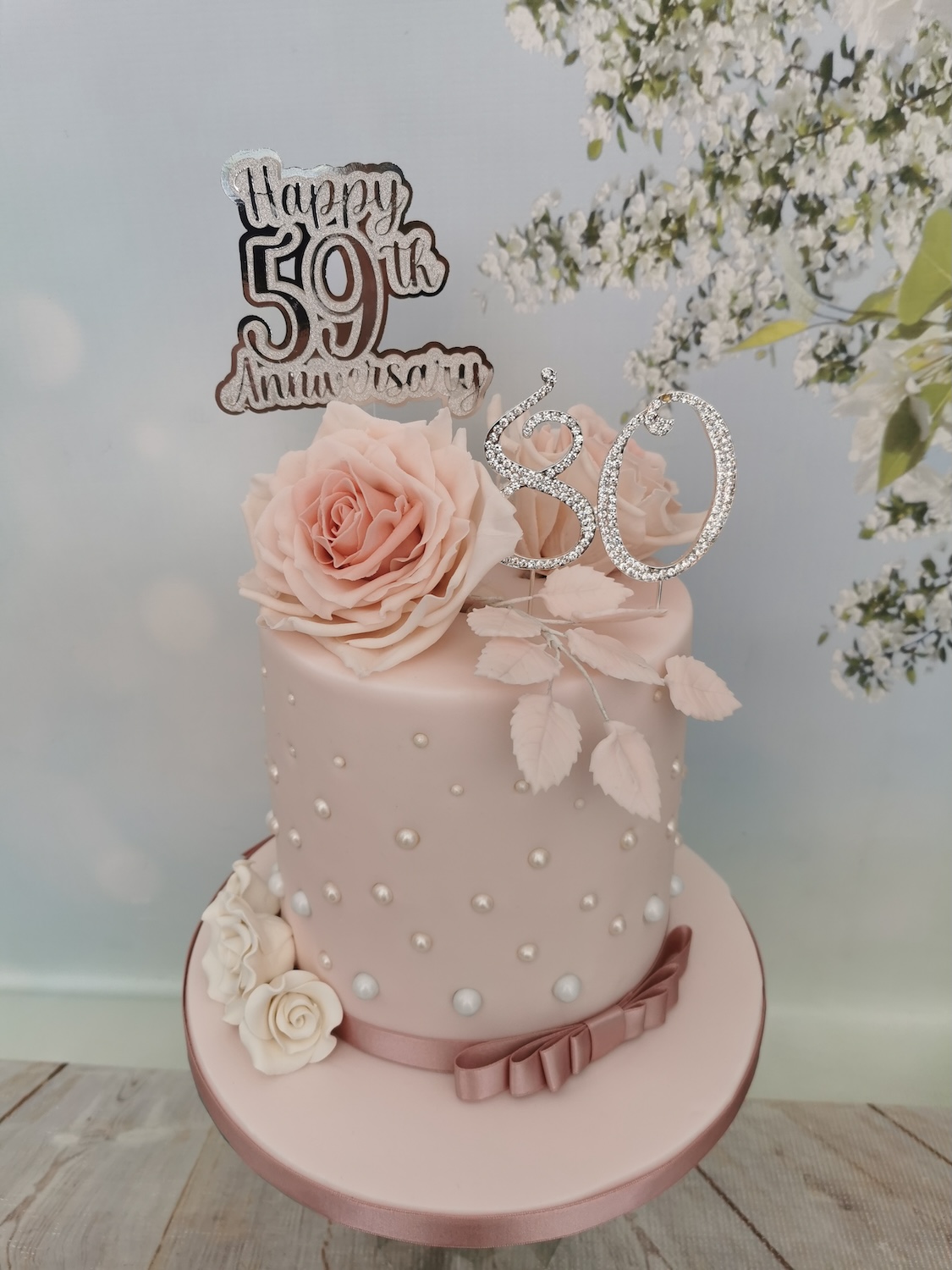 dusty pink birthday cake with pearls and roses