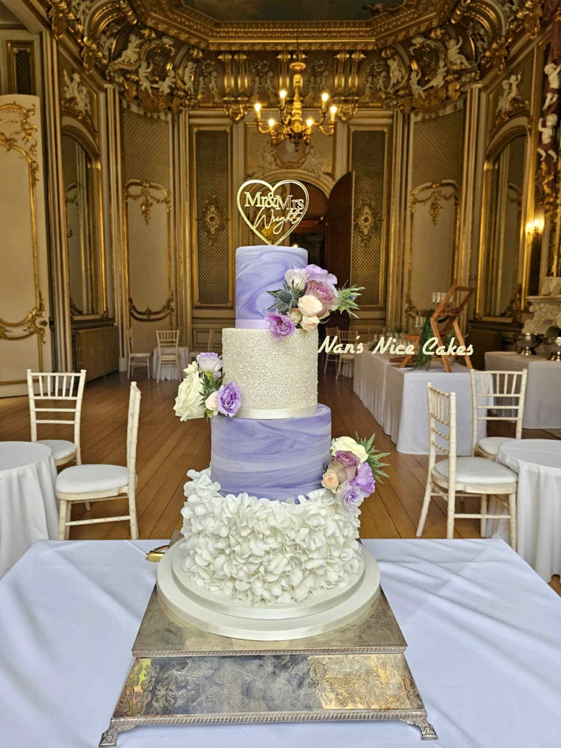 Lilac and gold 4 tier stunning wedding cake including 2 marble layers, one sparse layer and ruffles on the bottom layer - finished with beautiful handmade flowers