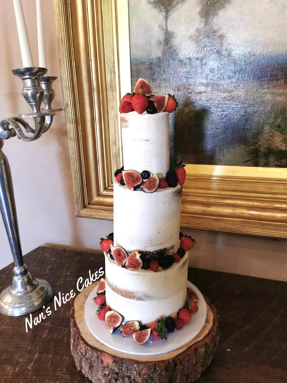 3 tier white wedding cake with fresh berries and fruit