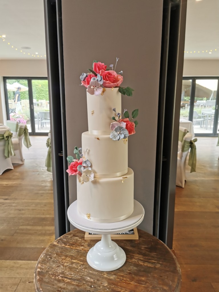 minimal white wedding cake with pink flowers