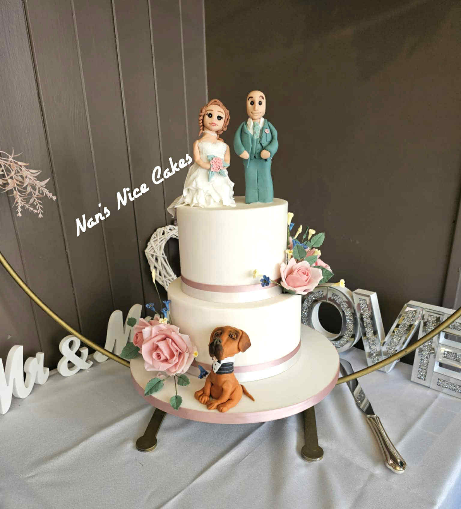simple white wedding cake with fondant bride groom and dog