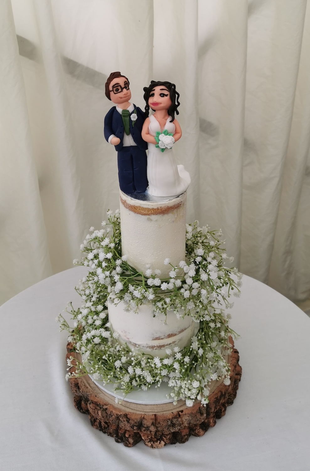 wedding cake with fondant handmade figures of the bride and groom