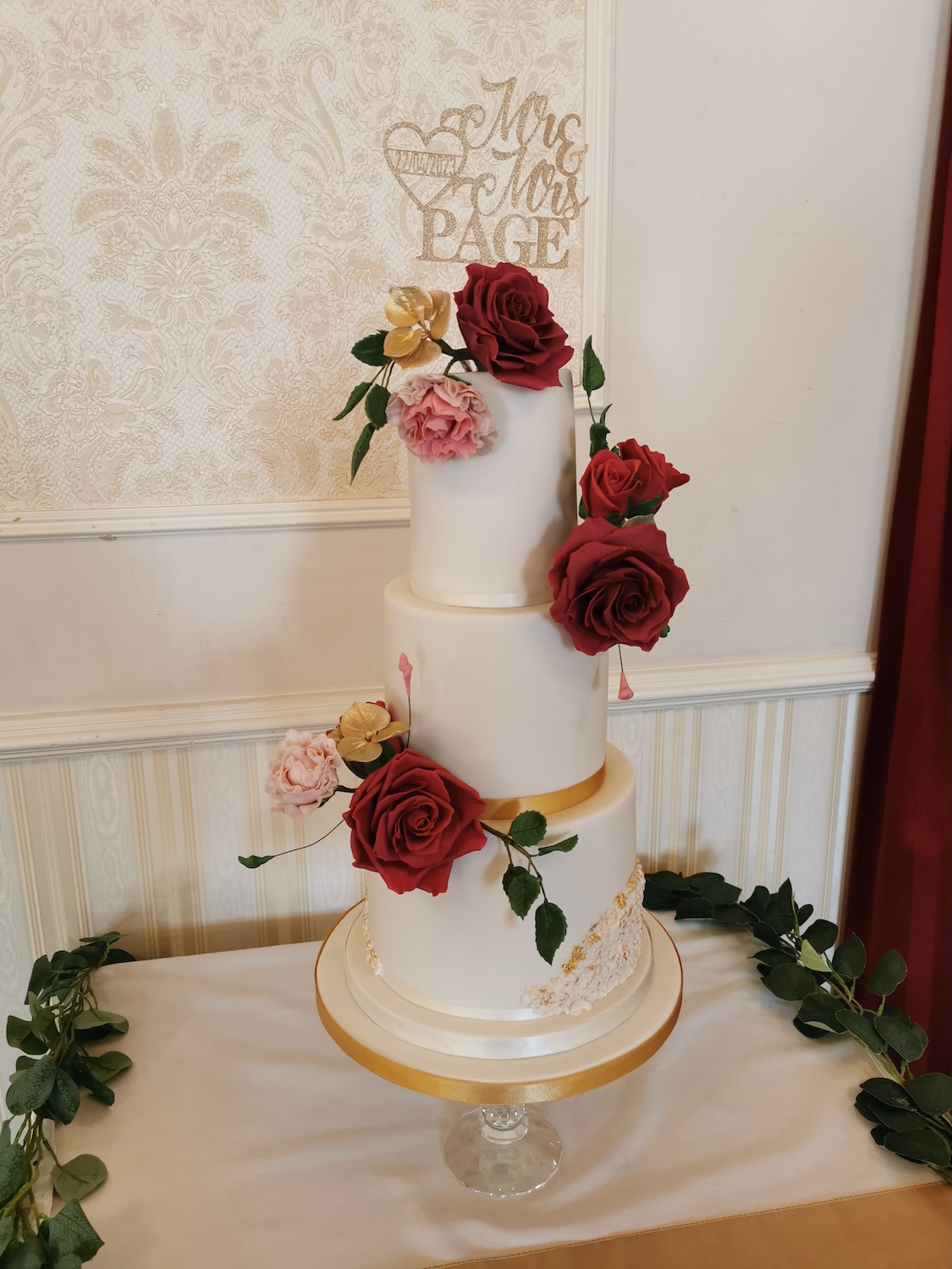 white wedding cake with red roses